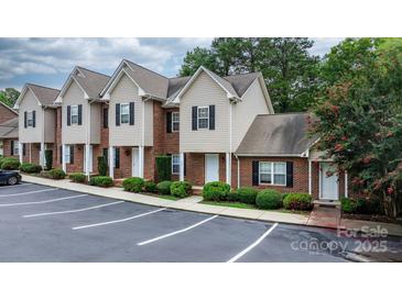 Exterior view of townhomes with manicured landscaping and designated parking spaces at 2222 15Th Ne Ave # 505, Hickory, NC 28601