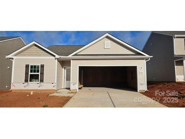 New construction home featuring neutral siding, an attached two-car garage, and a concrete driveway at 505 Maddox Dr, Shelby, NC 28152