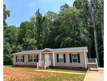 Charming single-story home features a well-maintained yard and inviting front entrance at 185 Crystal Bay Dr, Mooresville, NC 28115