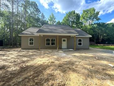 Charming single-story home with a covered front porch and a neutral-colored exterior at 318 Stanback St, Mount Gilead, NC 27306