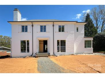 New two-story home featuring a white painted brick facade, classic shutters, and a well-manicured front yard at 3411 Seward Pl, Charlotte, NC 28211