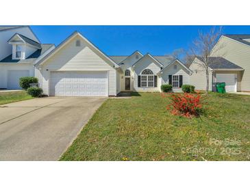 Charming single-Gathering home with a well-maintained lawn, attached garage, and inviting curb appeal at 6821 Parkers Crossing Dr, Charlotte, NC 28215