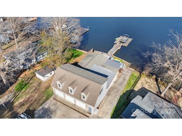 Aerial view showcasing the home's location with a dock, lake access, and three car garage at 938 Pinehaven Dr, New London, NC 28127