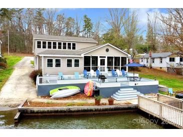 Lakefront home featuring a spacious deck, dock, and easy access to the water at 938 Pinehaven Dr, New London, NC 28127
