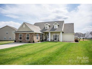 Charming single-Gathering home with stone accents, well-manicured lawn, and a welcoming covered front porch at 118 Heathrow Ln, Statesville, NC 28677