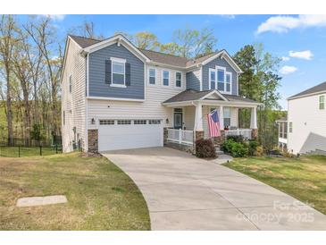 Charming two-story home featuring a welcoming front porch, two-car garage, and well-maintained landscaping at 18518 Lahaina Ln, Charlotte, NC 28278