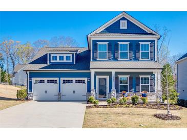 Charming two-story blue home with a well-manicured lawn and two-car garage at 1986 Thoreau Way, York, SC 29745
