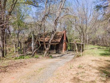 Charming rustic home with a covered front porch and driveway in a wooded setting at 2018 Fox Creek Trl, Lincolnton, NC 28092