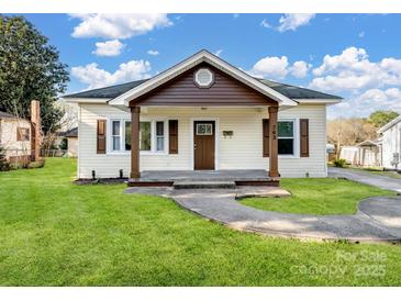 Charming home with a covered front porch, well-maintained lawn, and traditional architectural details at 703 Rankin Ave, Mount Holly, NC 28120