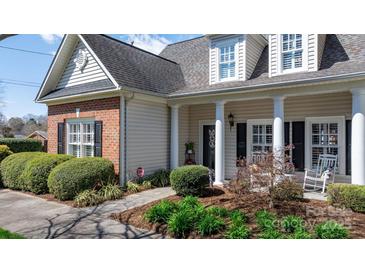 Charming home with a welcoming front porch, tidy landscaping, and classic architectural details at 71 40Th Avenue Ne Dr # 7, Hickory, NC 28601