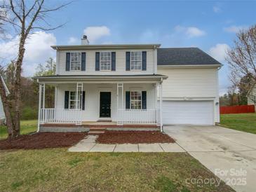 Charming two-story home with a welcoming front porch and attached two-car garage at 10827 Azure Valley Pl, Charlotte, NC 28269