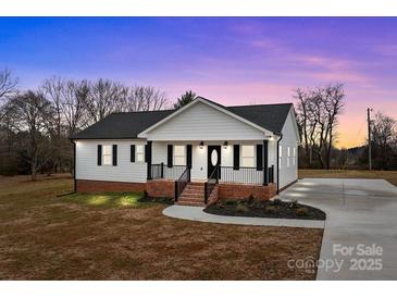 Charming single-story home with a welcoming front porch and well-maintained lawn at 111 Proust Rd, Statesville, NC 28625