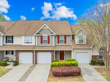 Charming townhome with a well-maintained front yard, single car garage, and brick and siding facade at 11308 Morgan Valley Ln, Charlotte, NC 28270
