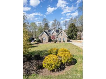 Landscaped front yard and beautiful lawn leading up to this lovely home at 124 Cedar Woods Dr, Mooresville, NC 28117