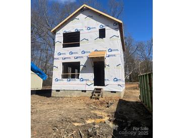 New construction shows the exterior of the house with protective moisture barrier material installed and awaiting cladding at 1587 Green Circle Dr, Gastonia, NC 28054