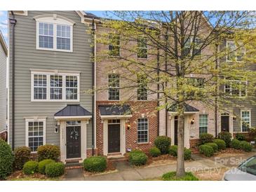 Charming townhomes showcasing varied facades, neat landscaping and covered entryways at 19737 Playwrights Way, Cornelius, NC 28031