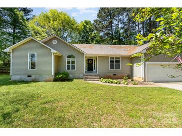 Charming single-story home featuring a well-maintained lawn and attached garage, perfect for suburban living at 2014 Cardinal Loop, Stanley, NC 28164