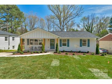 Charming single-story home with a well-manicured lawn, inviting curb appeal, and beautiful landscaping at 215 Wyanoke Ave, Charlotte, NC 28205