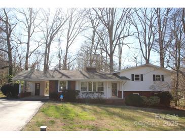 Charming, one-story home with a brick foundation, carport, and beautifully maintained front yard at 544 Stoneybrook Rd, Statesville, NC 28677