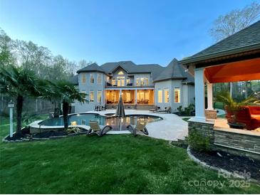Luxury home featuring a backyard pool with lounge chairs and outdoor living space, perfect for entertaining at 2017 Colorado Ct, Lancaster, SC 29720