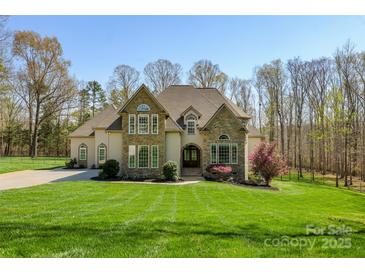 Stately home boasts a manicured lawn, stone accents, and a grand entrance, all bathed in sunlight at 2017 Colorado Ct, Lancaster, SC 29720
