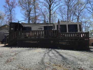 A charming RV featuring a spacious deck for outdoor entertainment and relaxation in a tranquil setting at 113 Larboard Trl # B36/37, Mount Gilead, NC 27306