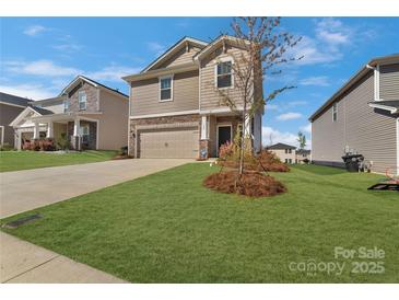 Charming two-story home with a well-manicured lawn and neutral colored exterior at 126 Johns Cardinal Dr, Mooresville, NC 28115