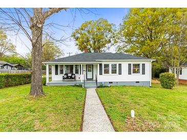 Charming single-story home with a welcoming front porch and well-maintained lawn on a sunny day at 1301 Jackson St, Kannapolis, NC 28083