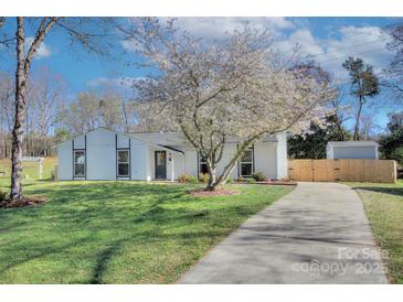 Charming home with a well-manicured lawn, beautiful tree, and a long driveway, creating inviting curb appeal at 6201 Sellars Ct, Charlotte, NC 28211