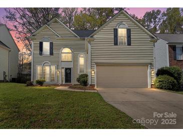 Charming two-story home featuring classic design elements and a well-manicured lawn at 6645 Allness Glen Ln, Charlotte, NC 28269