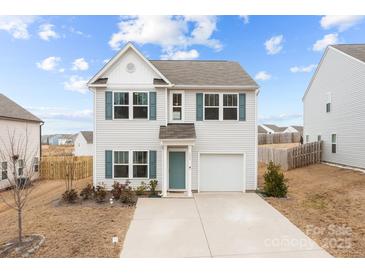 Charming two-story home with a well-manicured lawn and a blue door with beautiful curb appeal at 111 Buoy Ln # 392, Statesville, NC 28677