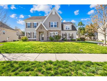 Charming two-story home with stone accents, manicured lawn, and inviting curb appeal at 2146 Holden Sw Ave, Concord, NC 28025