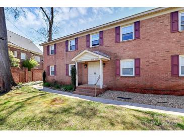 Charming brick building with maroon shutters and a well-manicured lawn at 2629 Vail Ave, Charlotte, NC 28204