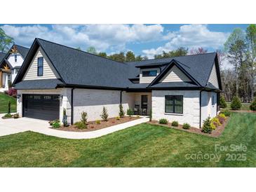 Charming single-story home featuring a well-manicured lawn, brick facade, and a paved walkway leading to the entrance at 4210 Holly Ne Cir, Conover, NC 28613