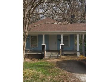 Charming single-story home featuring a welcoming front porch and light blue exterior at 4510 Wildwood Ave, Charlotte, NC 28208