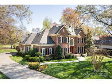 Beautiful brick home featuring manicured landscaping, black shutters, and a welcoming front entrance at 5419 Sunningdale Dr, Charlotte, NC 28277