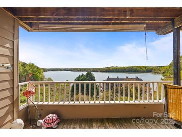 Relaxing balcony view overlooking a serene lake, perfect for enjoying the outdoors and nature at 9709 Emerald Point Dr # 6, Charlotte, NC 28278