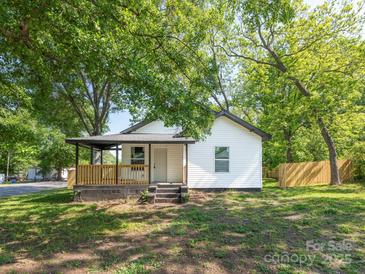 Charming home featuring a welcoming front porch and a classic white exterior with dark trim at 108 Graham St, Chester, SC 29706
