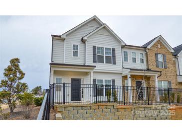 Charming two-story home features a black metal fence, neutral siding and trim, and an inviting facade at 1814 Saint Louis Nw Aly, Concord, NC 28027