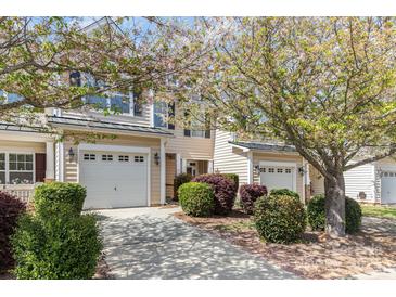 Inviting townhome exteriors showcasing manicured landscaping, garages and blossoming trees, enhancing curb appeal at 321 Rose Garden Ct, Rock Hill, SC 29732