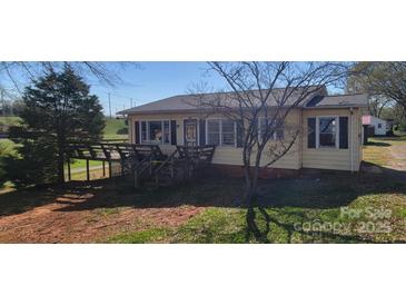 Charming yellow home with a quaint front porch and well-maintained lawn at 403 Branch St, Kings Mountain, NC 28086