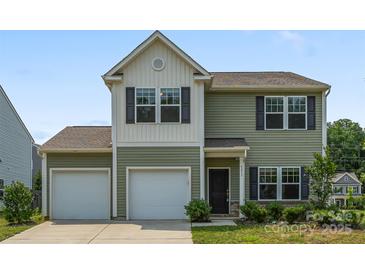 Charming two-story home featuring a two-car garage, neutral siding, and well-maintained landscaping at 4213 Stockbrook Dr, Charlotte, NC 28215