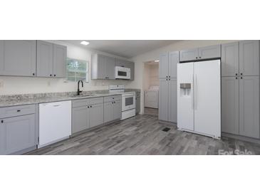 Modern kitchen featuring gray cabinets, stainless steel appliances, and granite countertops at 574 Pamela Rd, York, SC 29745