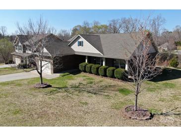 Charming brick home with mature landscaping and well-maintained lawn at 7283 Bradberry Ln, Denver, NC 28037