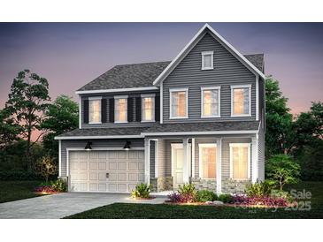 Charming two-story home featuring a gray exterior, attached garage, and well-maintained landscaping at 9519 Coast Laurel Nw Ave, Concord, NC 28027
