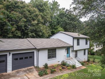 Charming two-story home with a gray roof, gray accents, and a bright blue front door at 105 Timber Ridge Rd, Belmont, NC 28012
