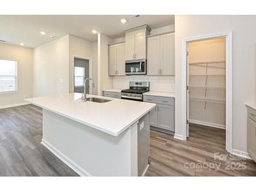 Modern kitchen with a large center island, stainless steel appliances, stylish cabinetry, and an open layout to living areas at 1234 Morehead Dr, Salisbury, NC 28144