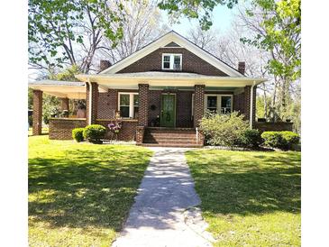 Charming brick home with a covered front porch and well-maintained lawn at 146 Saluda St, Chester, SC 29706
