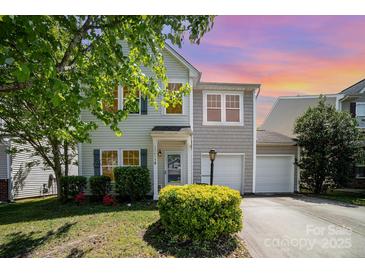 Charming two-story home with a well-manicured lawn and attached two-car garage at 15619 Lakepoint Forest Dr, Charlotte, NC 28278
