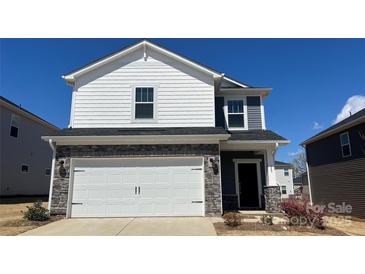 Charming two-story home featuring stone accents, white siding, and a spacious two-car garage at 159 Shepherds Landing Dr, Mooresville, NC 28115